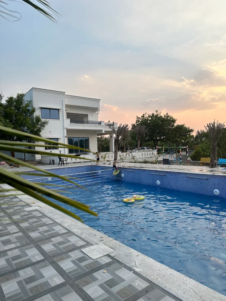 Swimming pool with sunset view at Green Enclaves